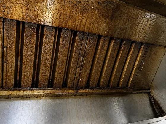 Grease buildup inside a commercial kitchen exhaust hood before cleaning